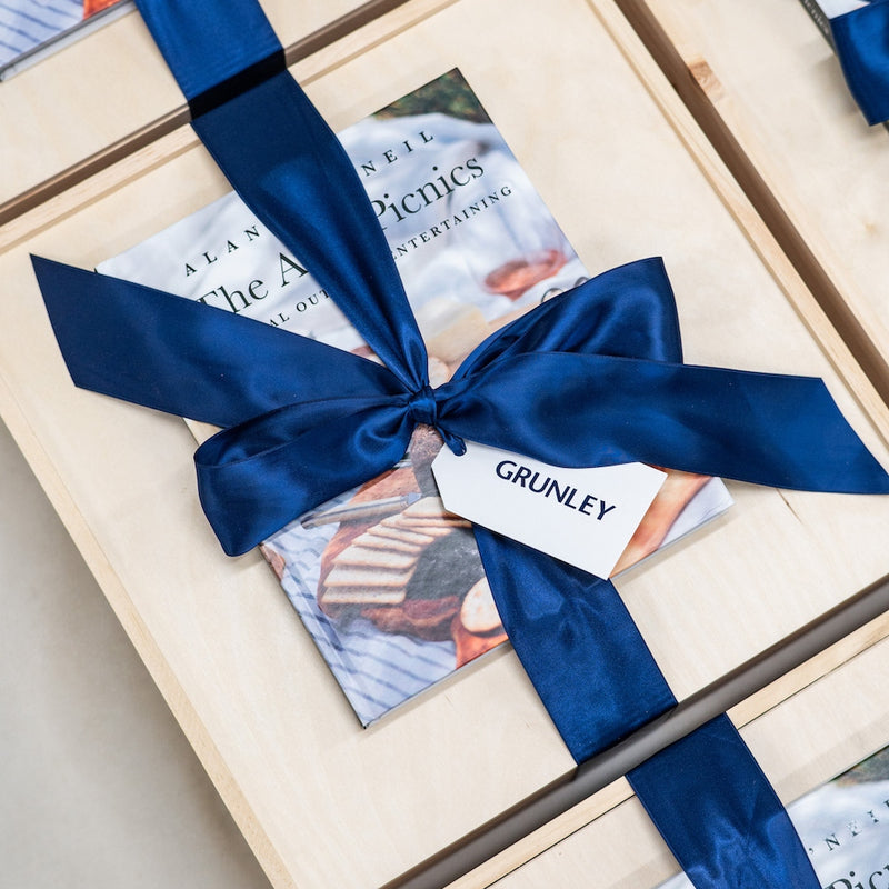 If the goal is to impress your clients with a gorgeous corporate appreciation gift, you'll love the custom corporate gifts with a luxurious picnic theme that we designed for Grunley Construction.